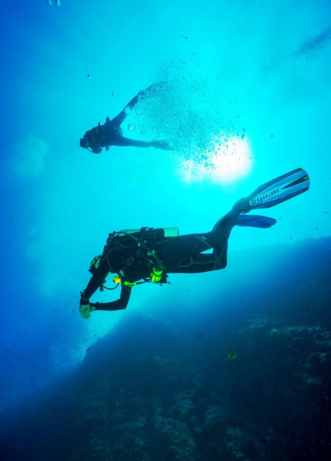 image showing two divers underwater
