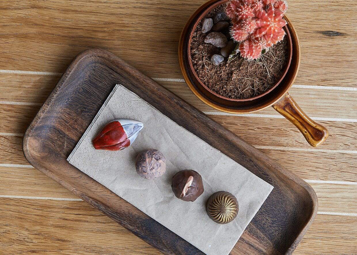 an example of food and drink photography from Spencer Cobby Photography showing a petit fours dish from The Flat Restaurant, Exeter on a table with a plant